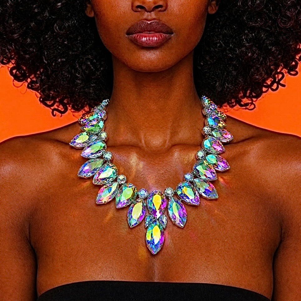 Woman wearing a colorful necklace against an orange background