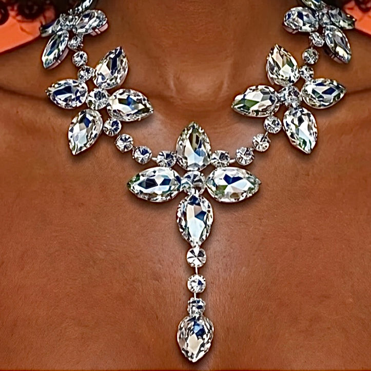 Close-up of a sparkling necklace with clear gemstones on a brown background