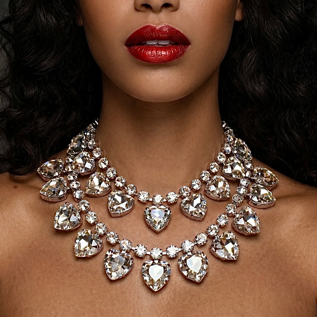 Close-up of a woman wearing a sparkling diamond necklace with red lipstick.